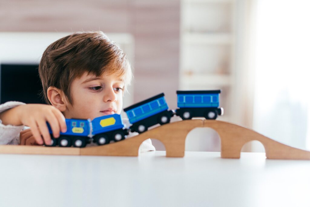 kid playing with toy train 1
