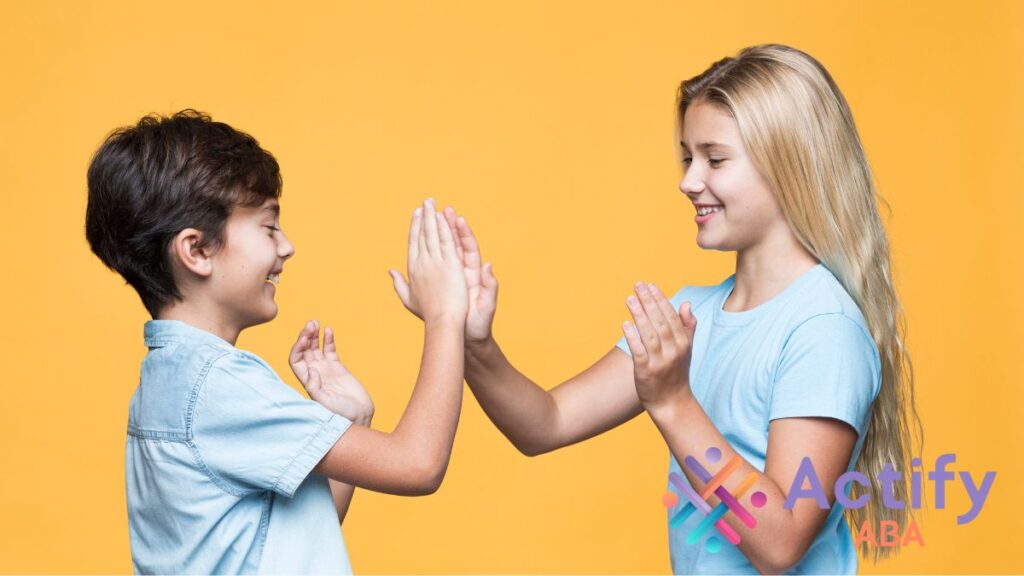 A boy and a girl share a high five, showing support and teamwork in autism advocacy.
