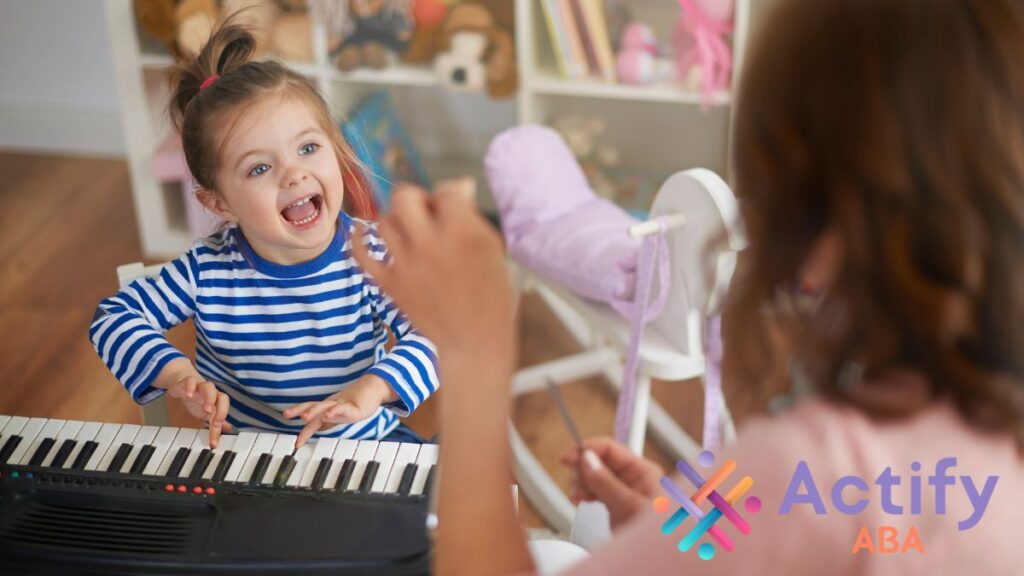 A young girl plays an electric organ while an instructor gently guides her, highlighting supportive learning for children with autism and sound sensitivity.