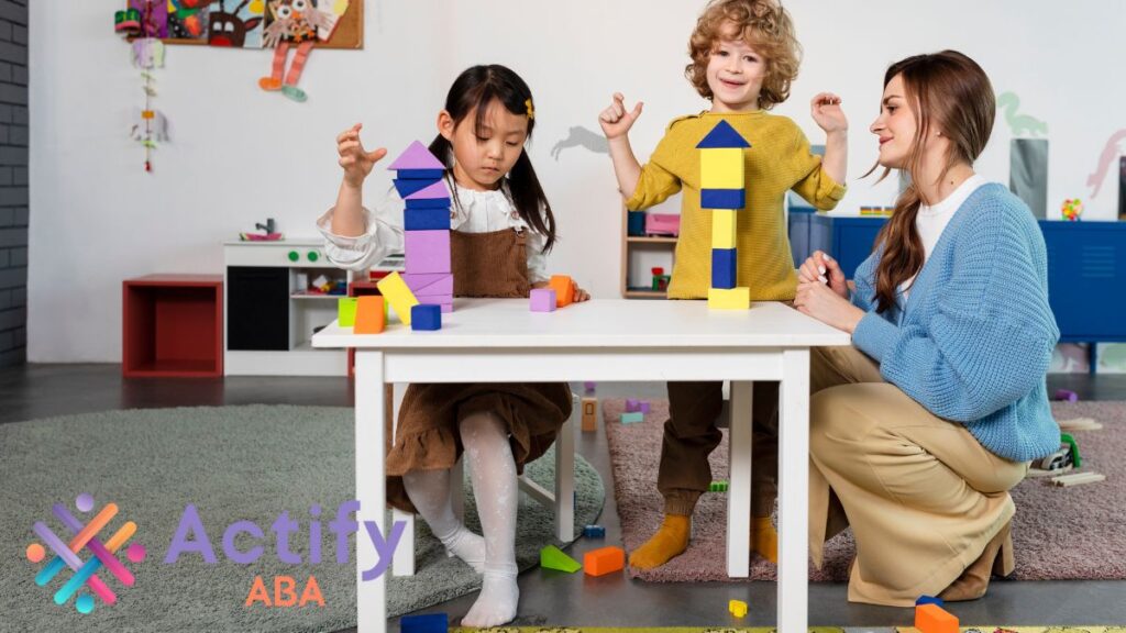 How many hours of ABA therapy is needed: Two children engage in social play with toy blocks, learning cooperation through shared fun.