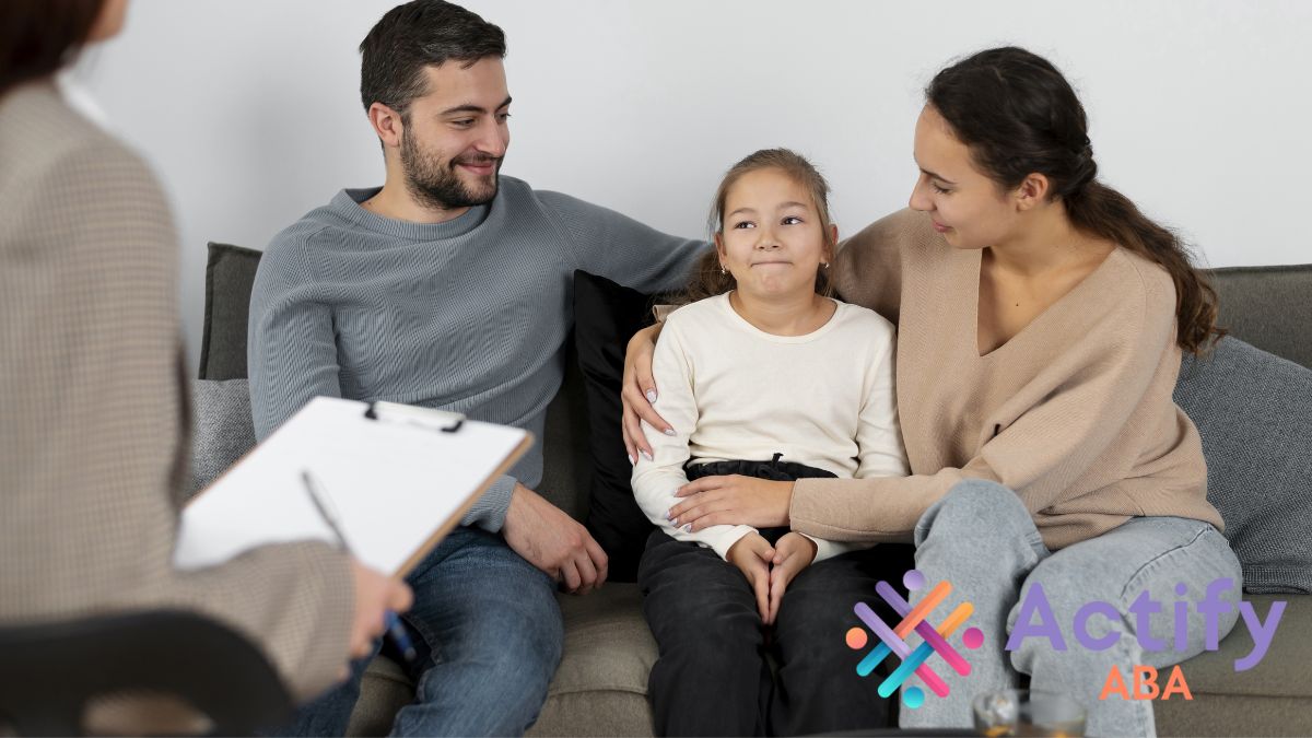 Parents attend an IEP consultation for their child, with their daughter sitting between them, focused and engaged in the discussion.