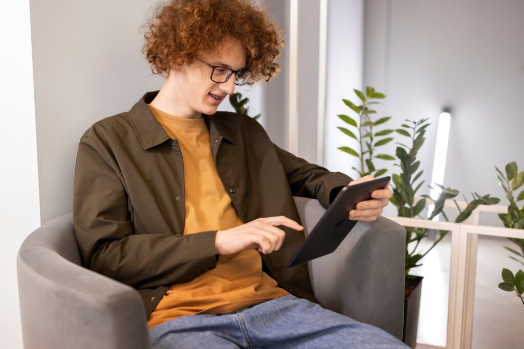 medium shot man reading digital magazine 1
