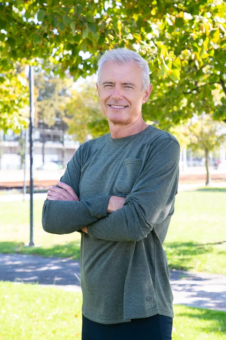 positive mature man with crossed