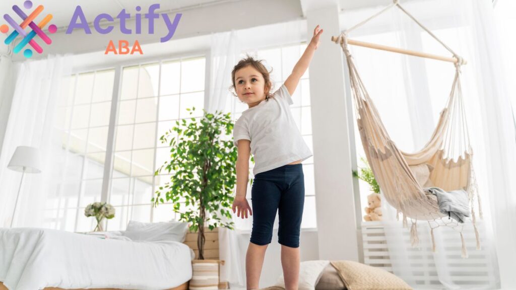 Proprioception autism: a young girl stands near sensory items and an indoor hammock.