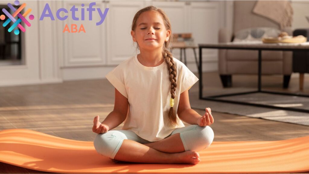 Proprioception autism: a young girl sits cross-legged on the floor, eyes closed, practicing a meditation exercise.