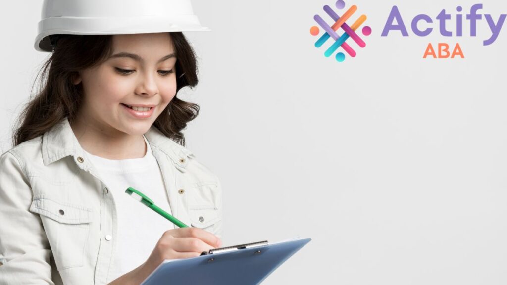 A young girl wearing a hard hat writes a list on a record tab with a backboard, illustrating ASD learning activity.